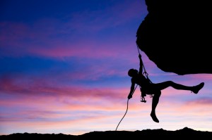 Rock climber rappelling.